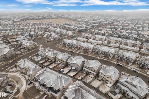 Aerial perspective showcasing a residential community with diverse architectural styles, including detached homes and townhouses - 718 177 Street, Edmonton, AB - Outdoor With View