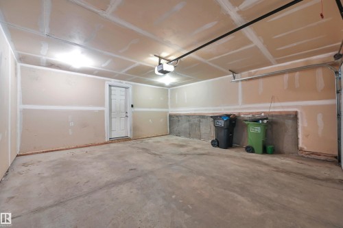 Spacious garage with exposed concrete flooring and unfinished drywall - 13 1030 Chappelle Boulevard, Edmonton, AB - Indoor Photo Showing Garage