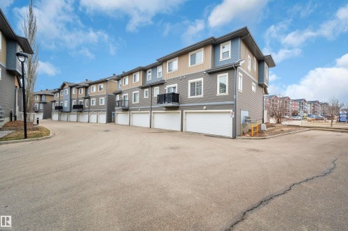 Multi-level townhome exteriors featuring horizontal siding in a palette of blues, grays, and tans - 13 1030 Chappelle Boulevard, Edmonton, AB - Outdoor