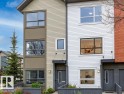 Contemporary townhome exteriors featuring multiple window styles, established landscaping, and a manicured lawn - 18, 2560 Pegasus Boulevard, Edmonton, AB  - Outdoor 