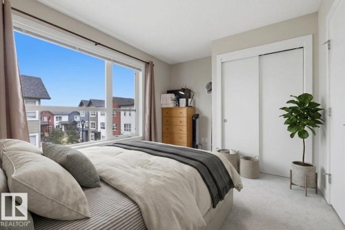 Expansive window offering exterior views - 18, 2560 Pegasus Boulevard, Edmonton, AB - Indoor Photo Showing Bedroom