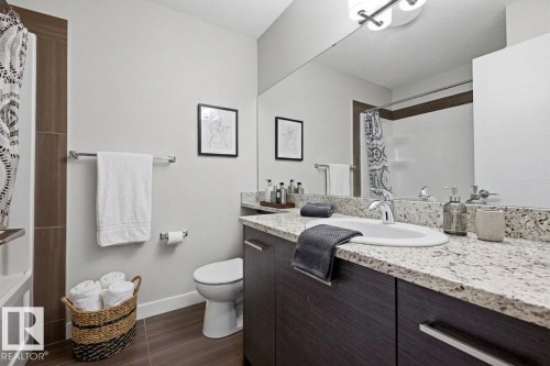 Bathroom featuring a dark wood-finish vanity with a granite countertop and an undermount sink - 18, 2560 Pegasus Boulevard, Edmonton, AB - Indoor Photo Showing Bathroom