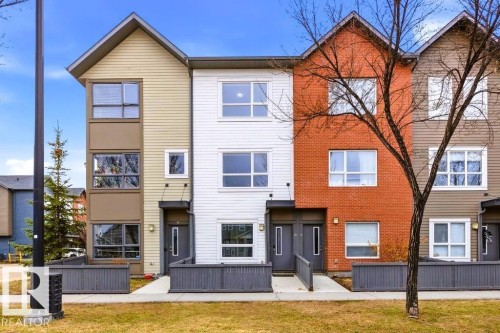 Contemporary townhome exterior featuring an orange brick facade - 18, 2560 Pegasus Boulevard, Edmonton, AB - Outdoor With Facade