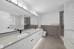 Double vanity featuring quartz countertops and matte black fixtures - 