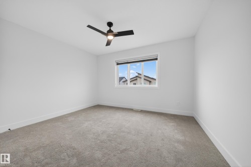 Spacious room with light gray carpeting and white walls - 7414 Chivers Crescent Sw, Edmonton, AB - Indoor Photo Showing Other Room