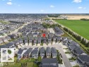 Residential community featuring a mix of modern homes, paved streets, and a greenbelt border - 7414 Chivers Crescent Sw, Edmonton, AB  - Outdoor With View 