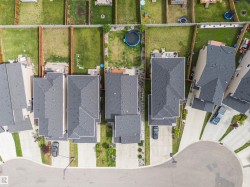 Aerial perspective showcasing residential properties with dark shingle roofing - 