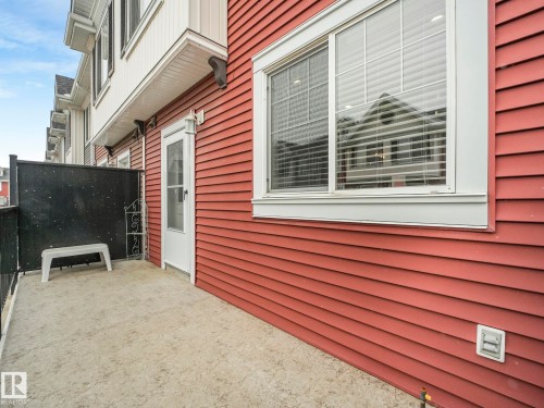 Outdoor patio featuring concrete flooring and a privacy screen - 96 8315 180 Avenue, Edmonton, AB - Outdoor With Exterior