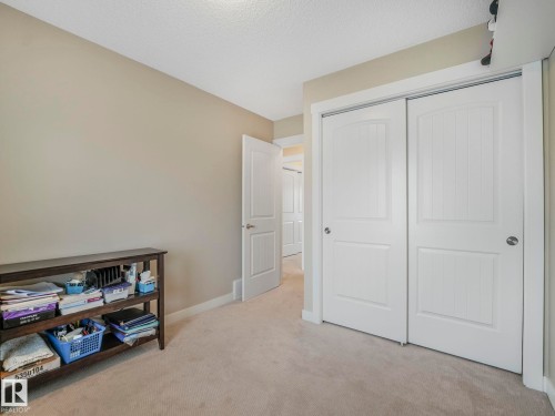 Wall-to-wall carpeting in a neutral tone, complemented by light beige painted walls - 96 8315 180 Avenue, Edmonton, AB - Indoor