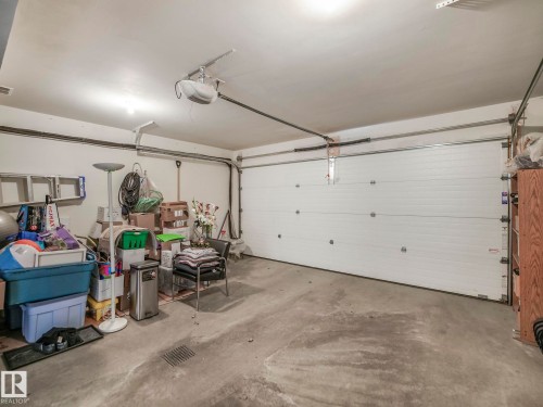 Garage with concrete flooring, overhead lighting, and a paneled garage door with an automatic opener - 96 8315 180 Avenue, Edmonton, AB - Indoor Photo Showing Garage
