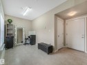 Spacious room featuring neutral wall tones, large format tile flooring, and white trim - 96 8315 180 Avenue, Edmonton, AB  - Indoor Photo Showing Other Room 