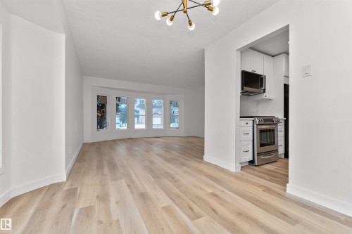 Open concept living space featuring wide plank wood-finish flooring - 3208 130 Avenue, Edmonton, AB - Indoor