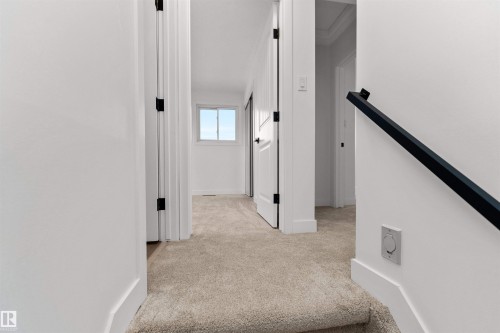 Carpeted hallway with white walls and trim - 3208 130 Avenue, Edmonton, AB - Indoor Photo Showing Other Room