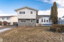 Split-level residence featuring a gray brick lower facade and light stucco upper - 3208 130 Avenue, Edmonton, AB  - Outdoor With Facade 