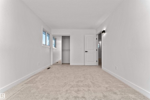 Spacious room with plush carpeting, white walls, and bright windows - 3208 130 Avenue, Edmonton, AB - Indoor Photo Showing Other Room
