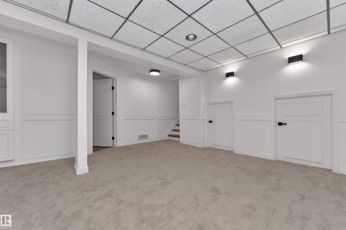 Spacious room featuring neutral carpet flooring, recessed ceiling lighting, and contemporary wall sconces - 3208 130 Avenue, Edmonton, AB - Indoor Photo Showing Other Room