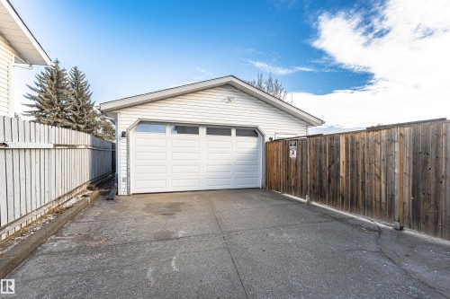 Detached garage with white siding and a paneled overhead door - 3208 130 Avenue, Edmonton, AB - Outdoor With Exterior
