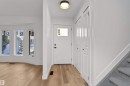 Entryway featuring a white paneled door with window insert, overhead flush mount lighting, light wood-finish flooring, and built-in closet storage - 3208 130 Avenue, Edmonton, AB  - Indoor Photo Showing Other Room 