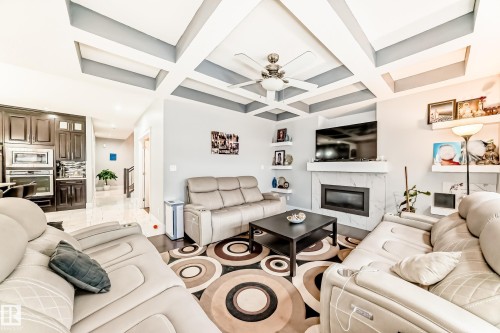 Living space featuring a coffered ceiling with recessed lighting and a ceiling fan - 69 Caragana Way, Fort Saskatchewan, AB 