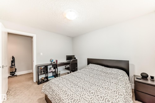 Neutral wall paint, textured ceiling, flush mount ceiling light, and carpeted flooring - 69 Caragana Way, Fort Saskatchewan, AB 