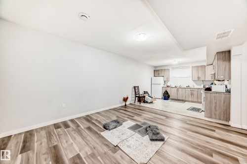 Open-concept living space featuring wood-finish flooring - 69 Caragana Way, Fort Saskatchewan, AB 