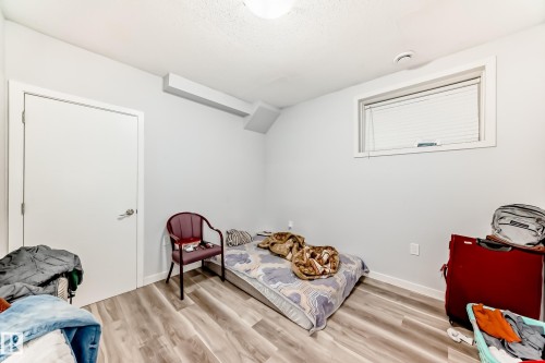 Neutral-toned room featuring light wood-finish flooring and white baseboards - 69 Caragana Way, Fort Saskatchewan, AB 