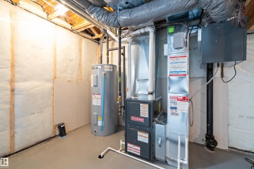 Utility area featuring a water heater, furnace, and exposed ductwork - 4235 Chichak Close, Edmonton, AB - Indoor Photo Showing Basement