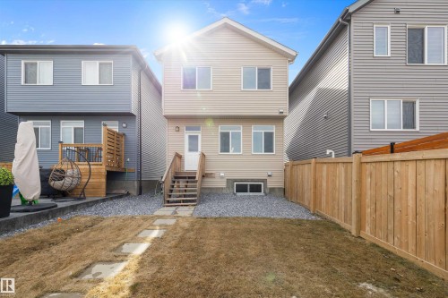 Rear elevation featuring light-colored horizontal siding and multiple windows - 4235 Chichak Close, Edmonton, AB - Outdoor