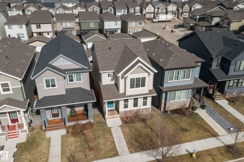 Modern two-story residence featuring a gray exterior, dark shingle roof, and white-framed windows - 4235 Chichak Close, Edmonton, AB - Outdoor With Facade
