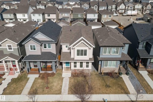 Modern two-story residence featuring light beige siding, an accent gable, and a covered front entry - 4235 Chichak Close, Edmonton, AB - 
