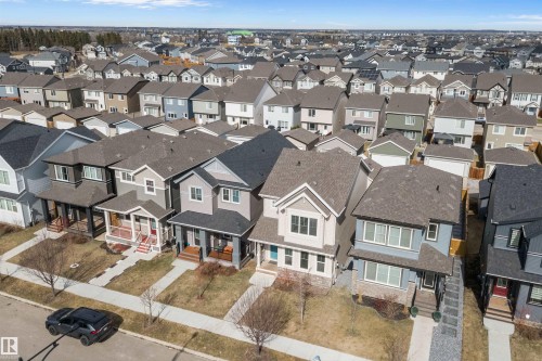 Residential streetscape featuring a collection of detached homes with varied architectural styles - 4235 Chichak Close, Edmonton, AB - Outdoor With Facade