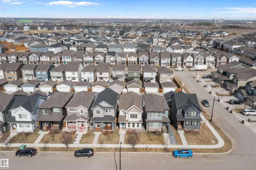 Aerial perspective highlighting a residential community with diverse architectural styles, paved streets, and sidewalks - 4235 Chichak Close, Edmonton, AB - Outdoor With View