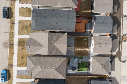 Residential development featuring multiple properties with pitched roofs, individual backyards, and dedicated parking - 4235 Chichak Close, Edmonton, AB - Outdoor