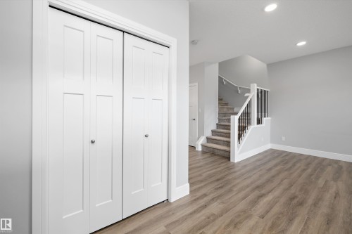 Bifold closet doors featuring panel detailing and chrome hardware - 4235 Chichak Close, Edmonton, AB - Indoor Photo Showing Other Room