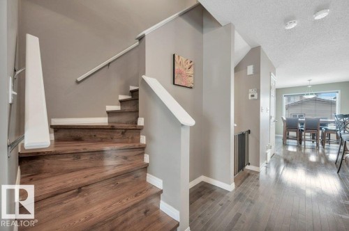 Staircase featuring wood-finish treads and white risers - 12063 19 Avenue, Edmonton, AB - Indoor Photo Showing Other Room