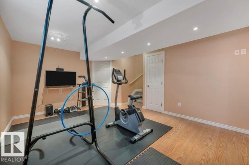 Versatile finished room featuring recessed lighting, light wood-finish flooring, and warm-toned wall paint - 12063 19 Avenue, Edmonton, AB - Indoor Photo Showing Gym Room