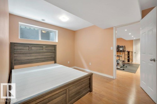 Recessed window with privacy blind, light wood-finish flooring, and a flush-mount ceiling light - 12063 19 Avenue, Edmonton, AB - Indoor Photo Showing Other Room