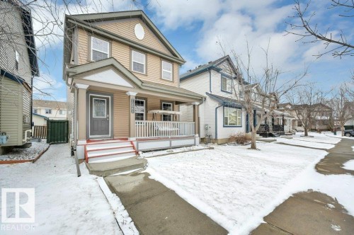 Two-story residence featuring light brown siding and white trim - 12063 19 Avenue, Edmonton, AB - Outdoor With Deck Patio Veranda With Facade