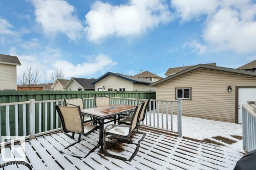 Spacious wood-finish deck with a white railing and privacy fencing - 12063 19 Avenue, Edmonton, AB - Outdoor With Deck Patio Veranda With Exterior