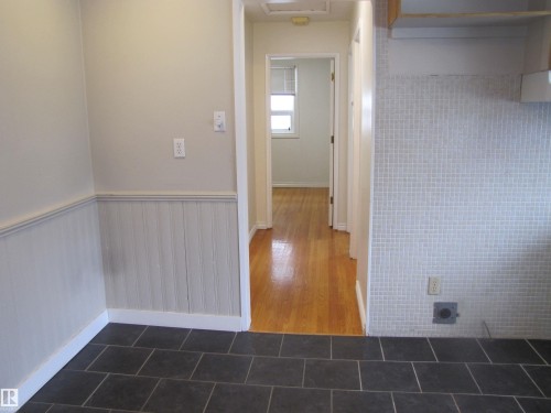 Hard-surface flooring options featuring dark rectangular tiles and polished wood-finish flooring - 7135 87 Street, Edmonton, AB - Indoor Photo Showing Other Room