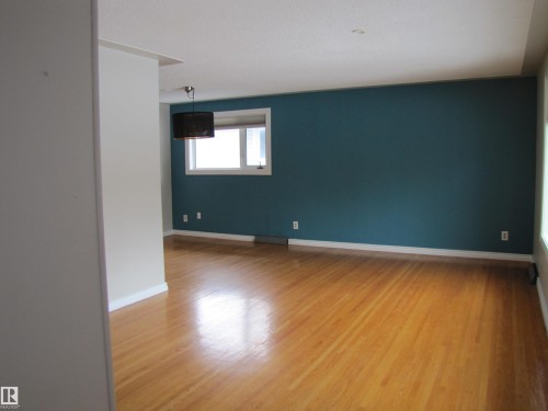 Hardwood-style flooring throughout - 7135 87 Street, Edmonton, AB - Indoor Photo Showing Other Room