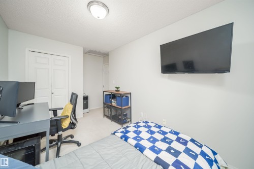 Room featuring light-toned walls, recessed lighting, and soft carpet flooring - 50 14603 Miller Boulevard, Edmonton, AB - Indoor Photo Showing Bedroom