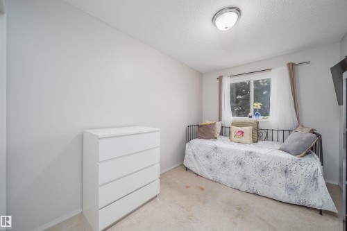 Neutral-toned room with light-colored carpeting and a single window - 50 14603 Miller Boulevard, Edmonton, AB - Indoor Photo Showing Bedroom