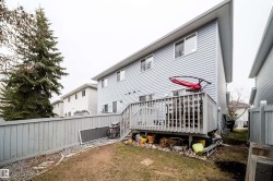 Rear exterior with light blue vinyl siding - 
