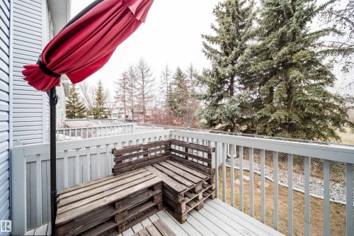 Spacious outdoor deck featuring light-colored wood flooring and a perimeter railing - 50 14603 Miller Boulevard, Edmonton, AB - Outdoor