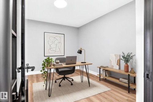 Versatile room featuring wood-finish flooring, light grey painted walls, and a ceiling-mounted light fixture - 520 7463 May Common, Edmonton, AB - Indoor Photo Showing Office