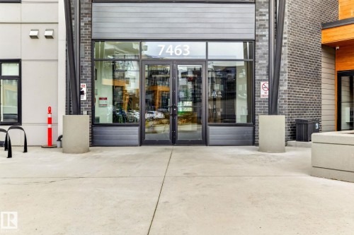 Contemporary building entrance featuring glass double doors - 520 7463 May Common, Edmonton, AB - Outdoor