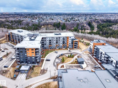 Modern apartment buildings featuring multi-toned facades with orange and gray accents - 520 7463 May Common, Edmonton, AB - Outdoor With View