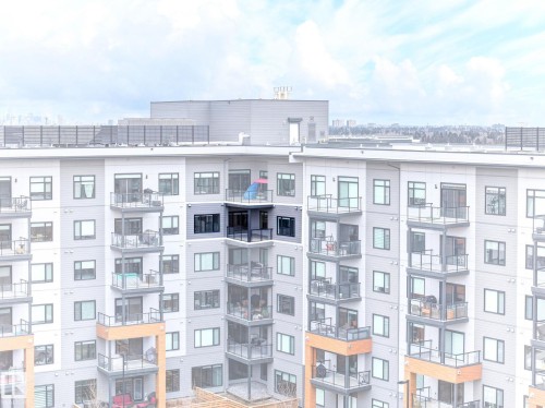 Multi-story residential building featuring a light gray and dark gray facade with white trim - 520 7463 May Common, Edmonton, AB - Outdoor With Facade