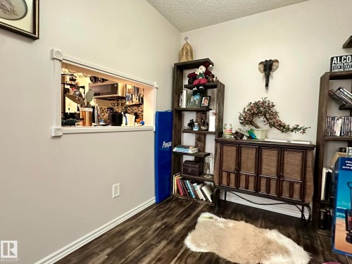 Interior pass-through window with decorative trim - 211 9619 174 Street, Edmonton, AB - Indoor Photo Showing Other Room